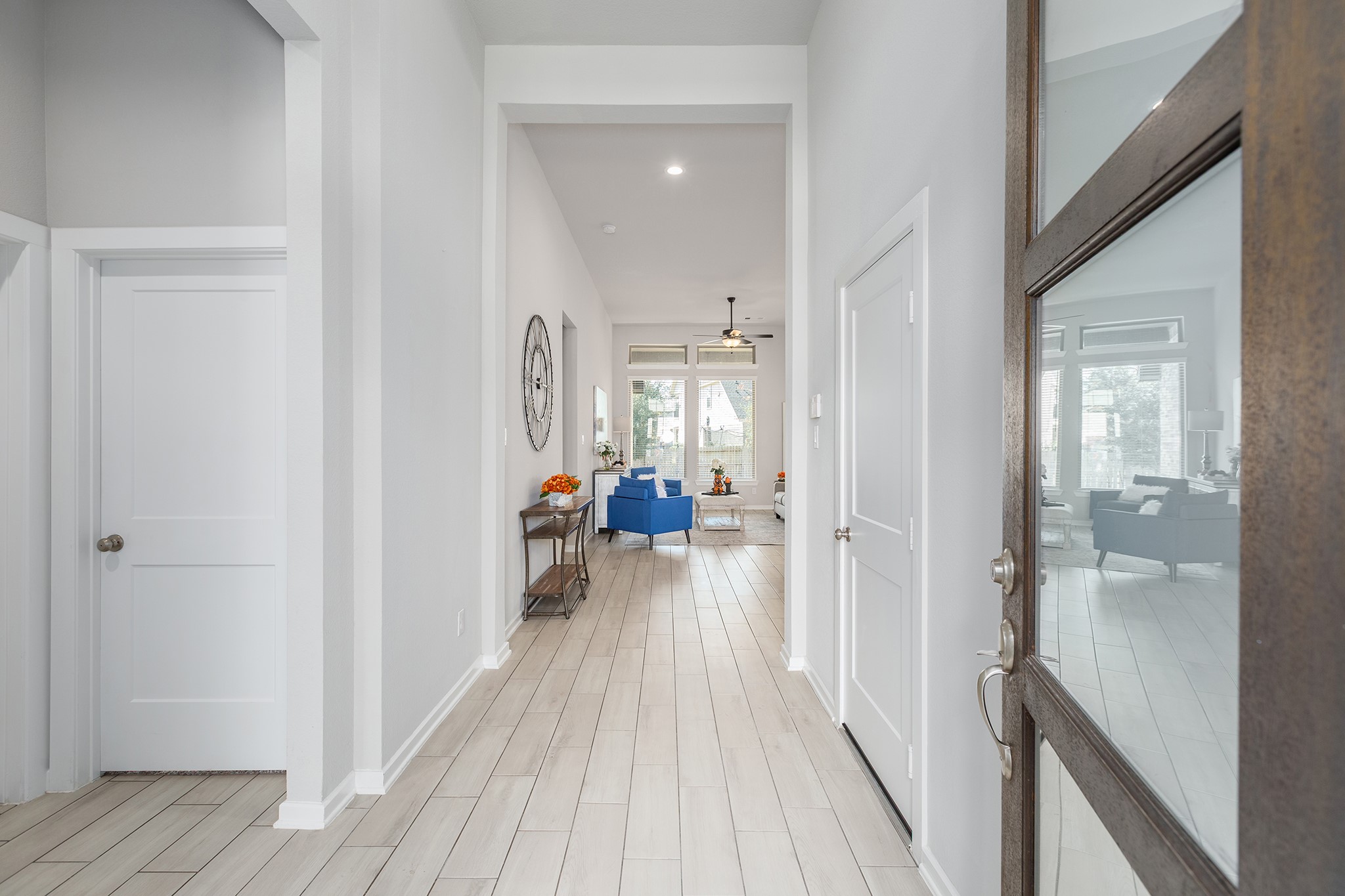 107 Yellow Perch Way Conroe, TX 77318 - Photo 16 of 44 Inviting entry hallway featuring tile flooring and a clear sightline to the living area, creating an open and welcoming first impression.