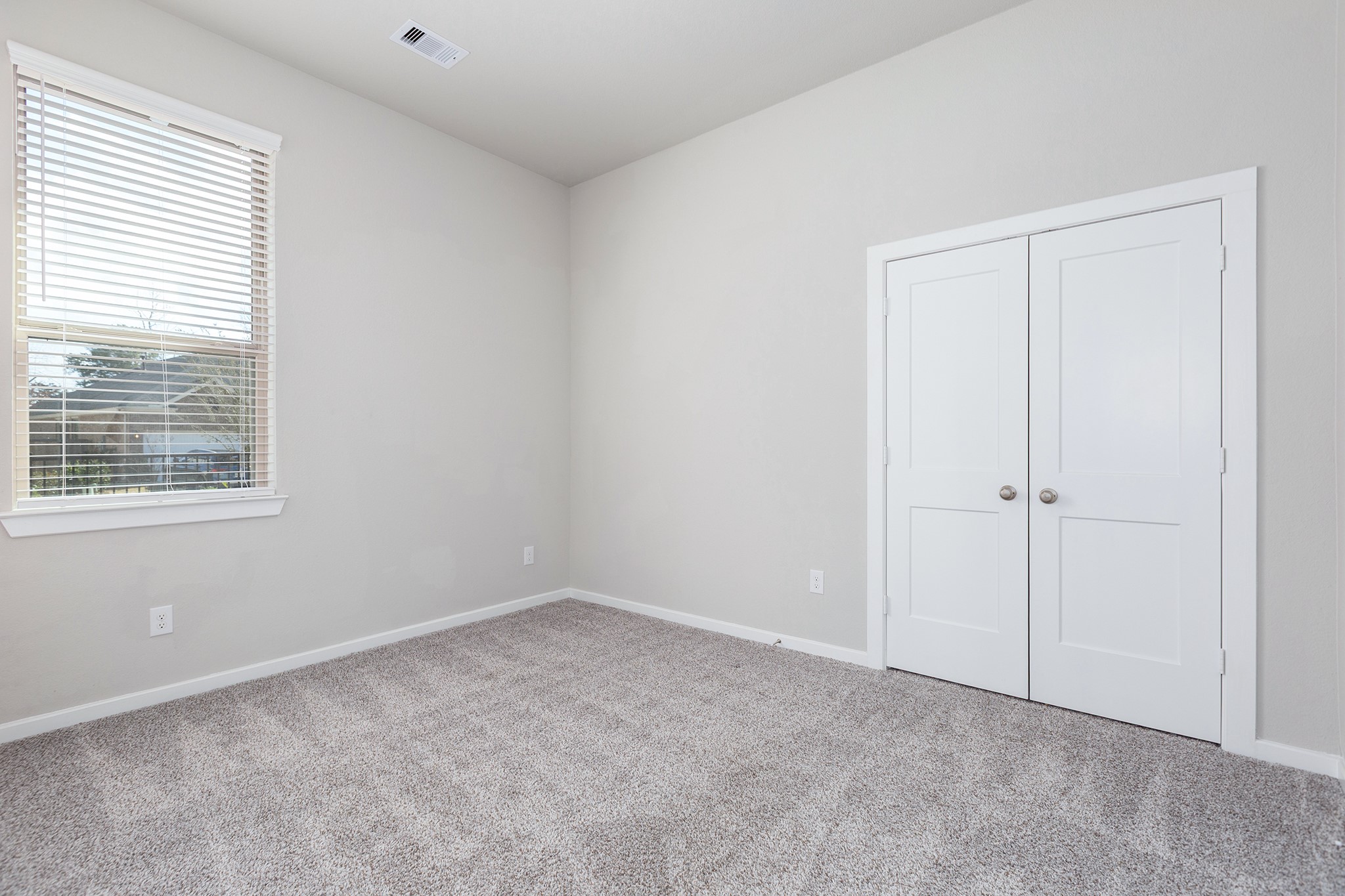 107 Yellow Perch Way Conroe, TX 77318 - Photo 28 of 44 Secondary bedroom featuring neutral finishes, natural light, and flexible space suitable for guests or everyday use.