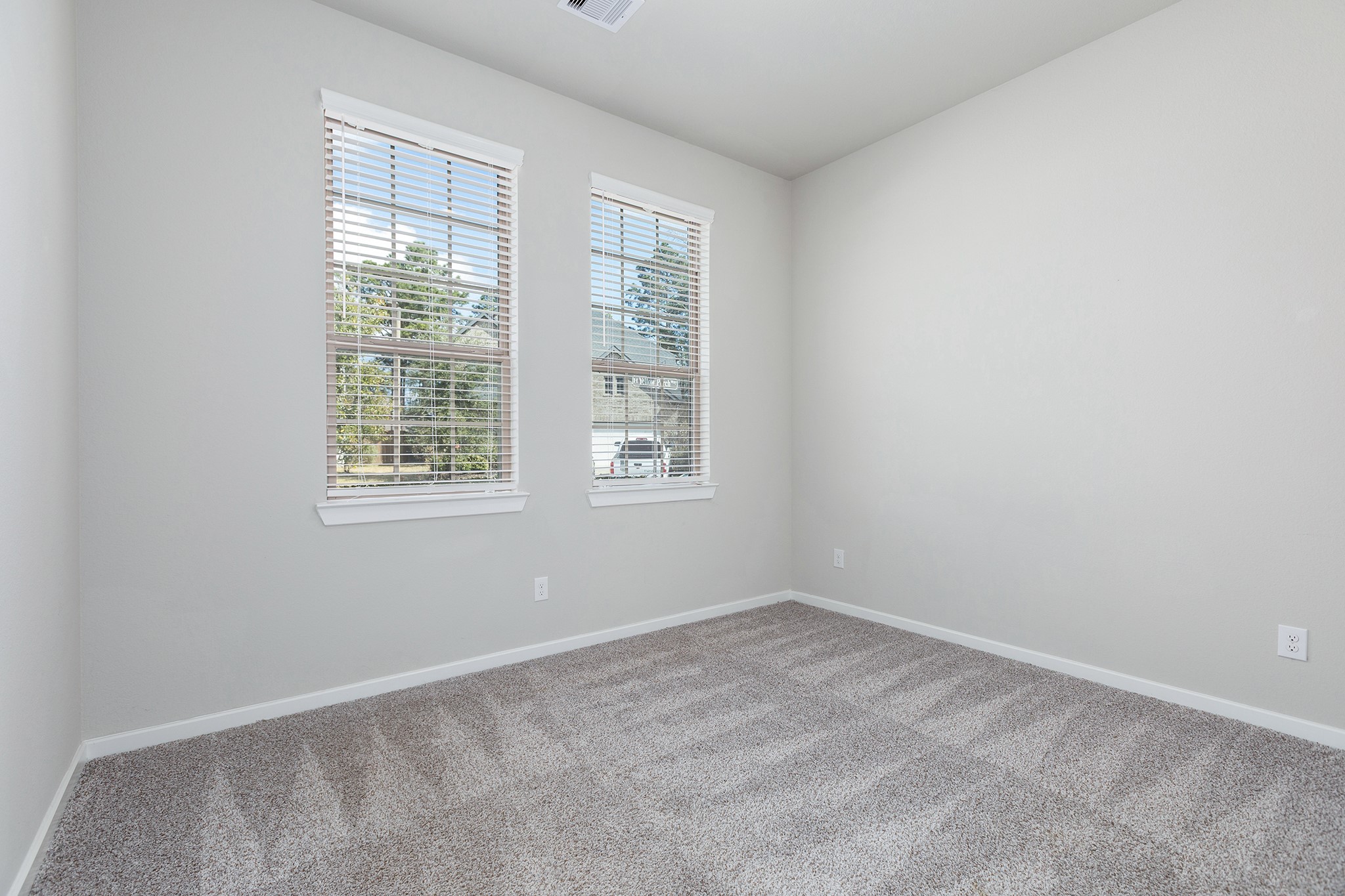 107 Yellow Perch Way Conroe, TX 77318 - Photo 29 of 44 Bedroom 3 with neutral finishes and a functional layout, providing flexible additional living space.