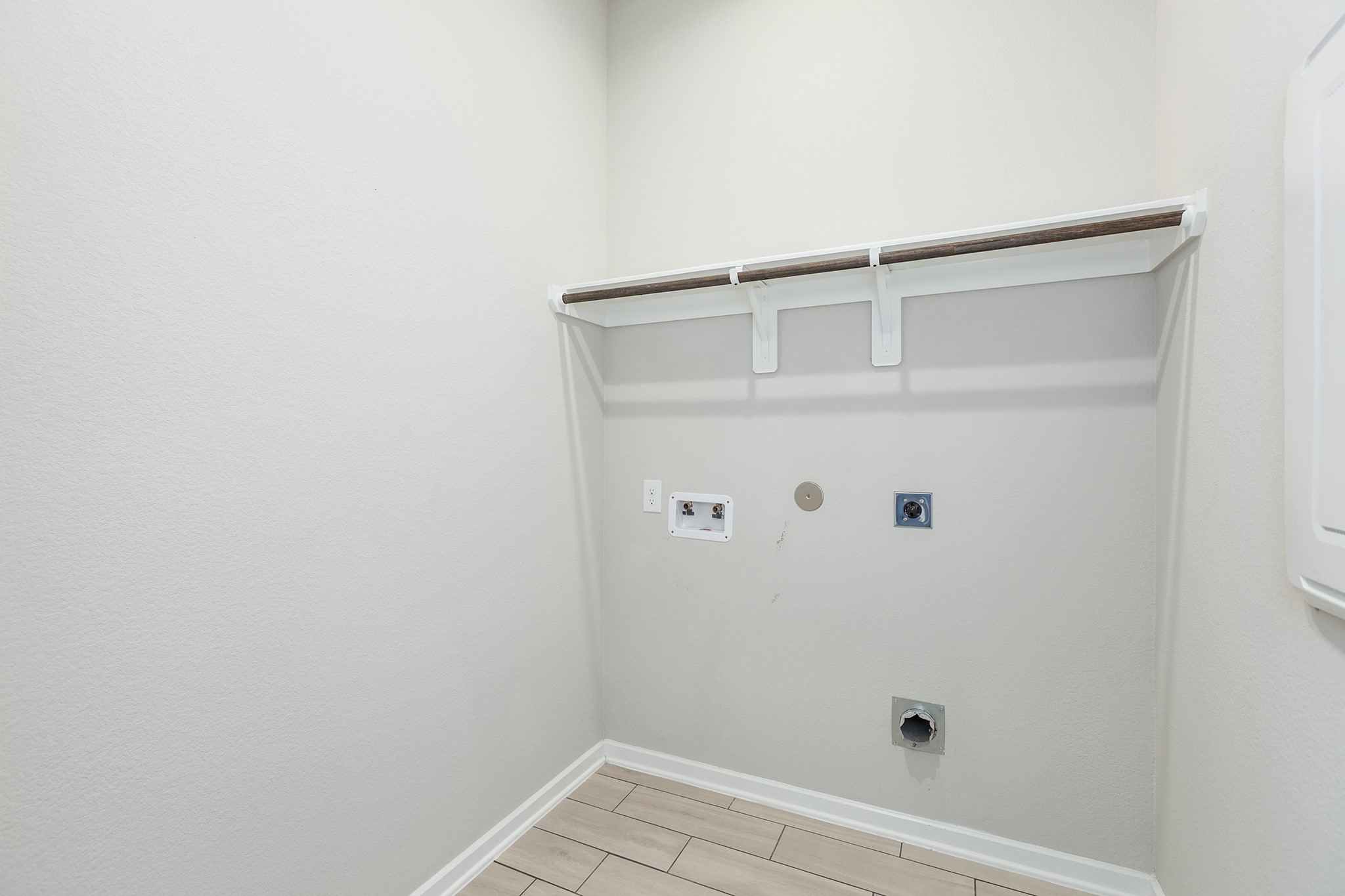 107 Yellow Perch Way Conroe, TX 77318 - Photo 31 of 44 Utility room with washer and dryer connections, overhead shelving, and space for everyday laundry needs.