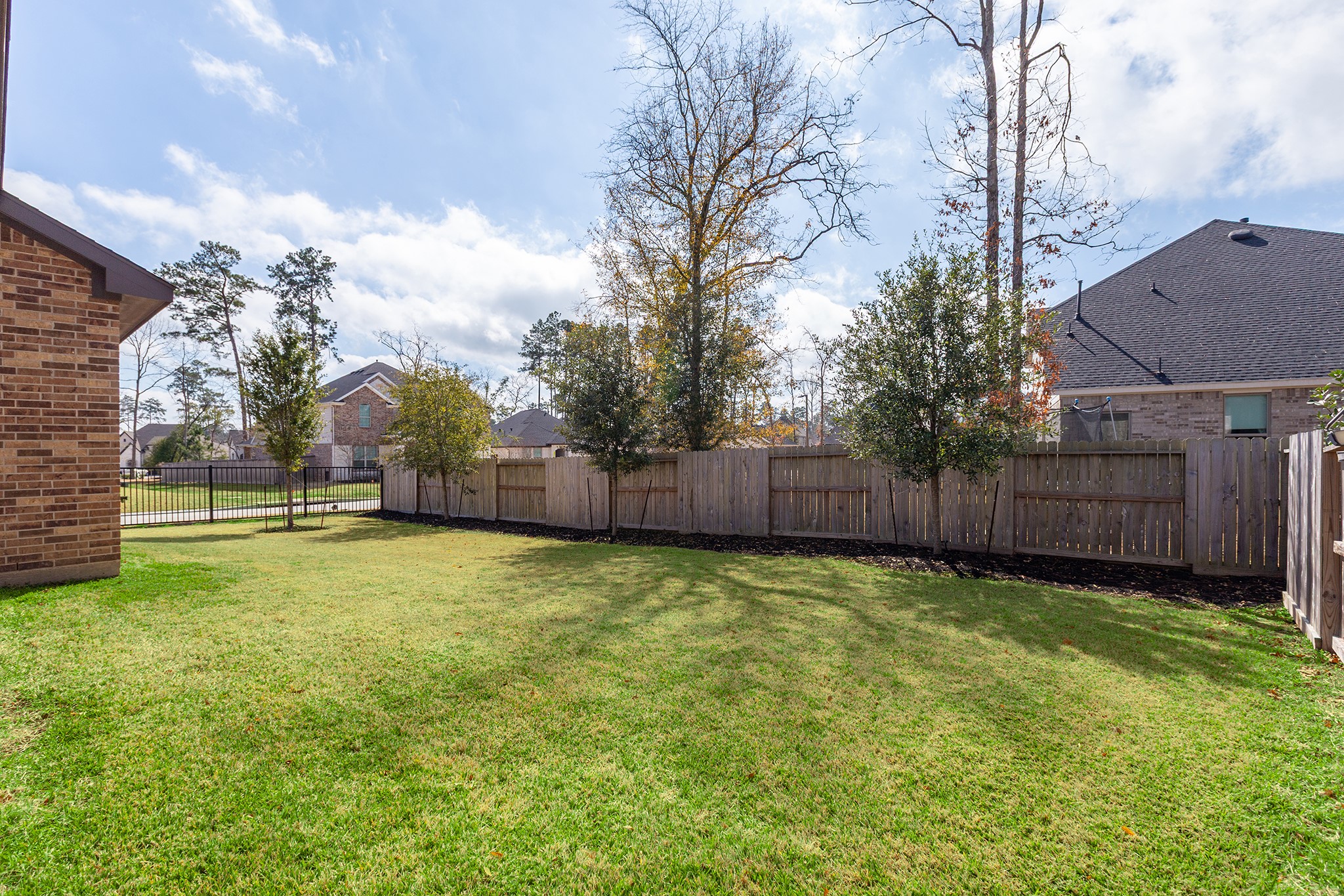 107 Yellow Perch Way Conroe, TX 77318 - Photo 35 of 44 This generous backyard offers space to envision a private pool or outdoor living area, with the added bonus of enjoying The Woodlands Hills’ resort-style community pools just minutes away.