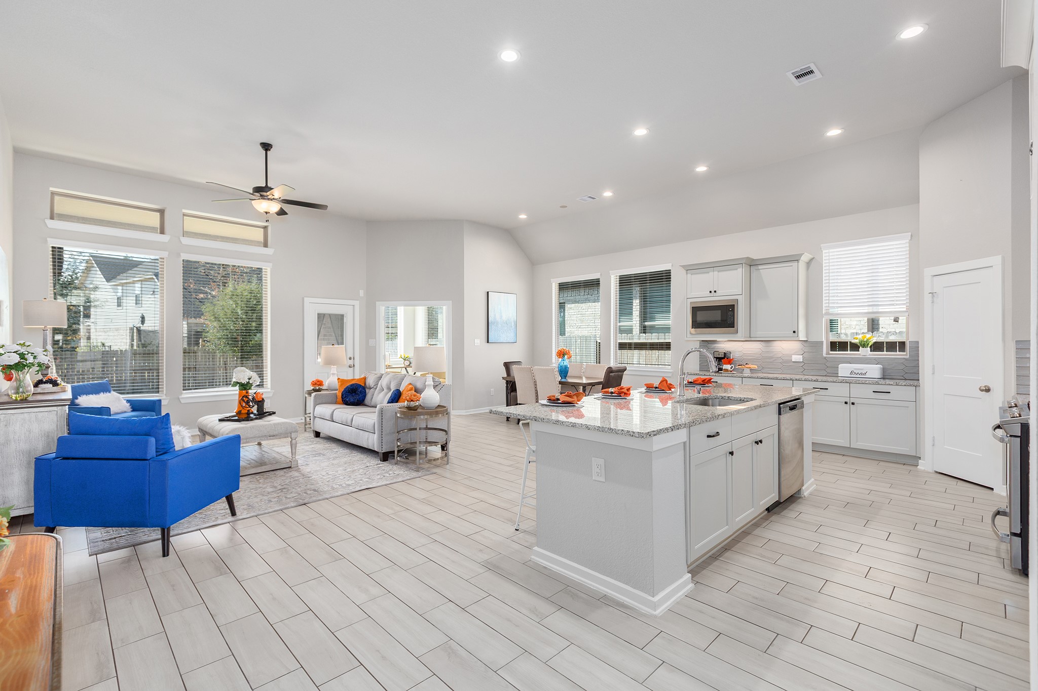 107 Yellow Perch Way Conroe, TX 77318 - Photo 4 of 44 Spacious living room with vaulted ceilings, tile flooring, and abundant natural light.
