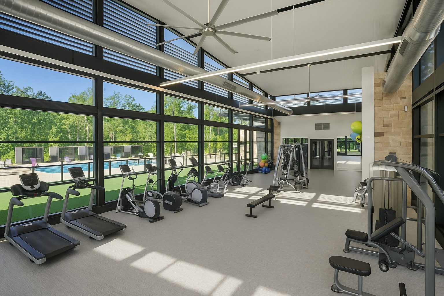 107 Yellow Perch Way Conroe, TX 77318 - Photo 41 of 44 Another view of The Woodlands Hills community fitness center featuring modern equipment and spacious, light-filled workout areas for residents.