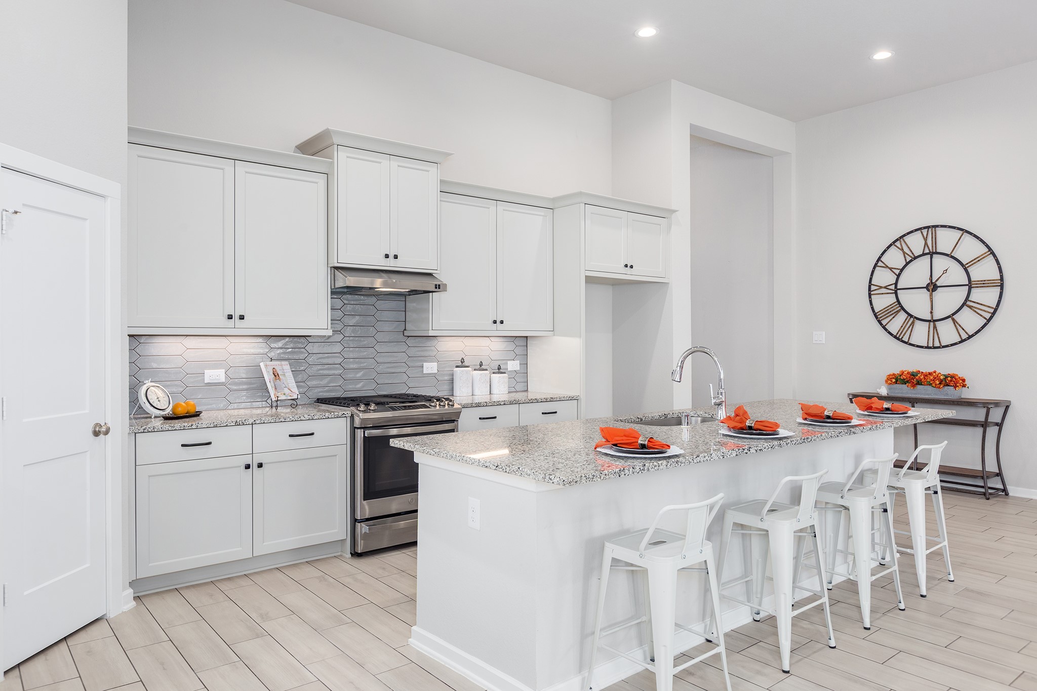 107 Yellow Perch Way Conroe, TX 77318 - Photo 7 of 44 This expansive kitchen offers stainless steel appliances, granite countertops, crisp white cabinetry, and an oversized island with seating, making it ideal for both everyday living and entertaining.