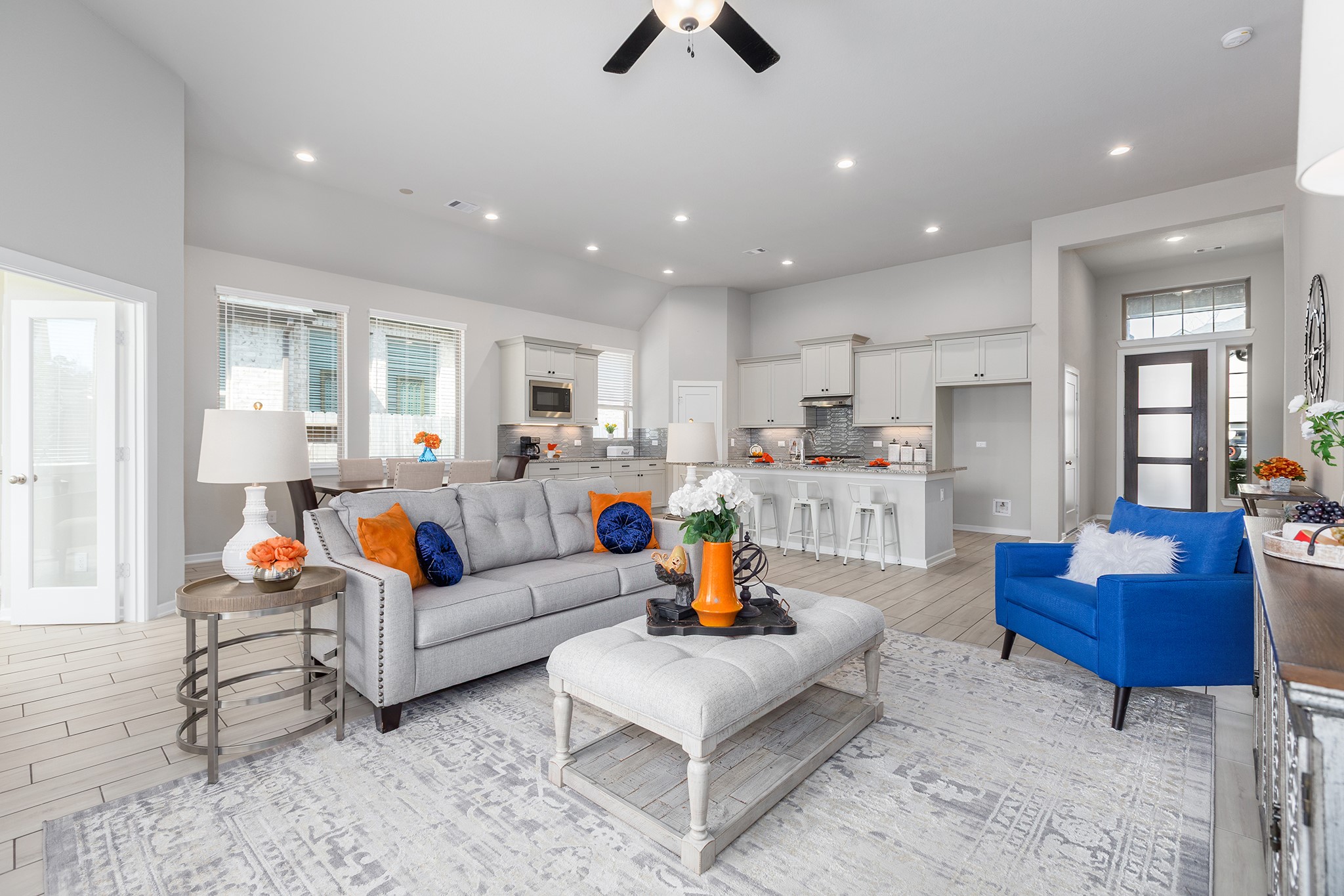 107 Yellow Perch Way Conroe, TX 77318 - Photo 9 of 44 Open-concept living area featuring vaulted ceilings, recessed lighting, tile flooring, and seamless flow into the kitchen, creating an inviting space for everyday living and entertaining.