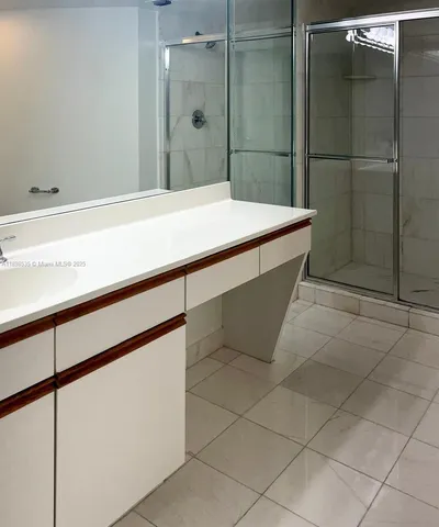 a bathroom with a tub and shower