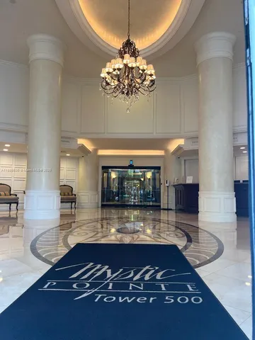a room with lots of wooden floor and chandelier