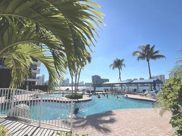 a view of a swimming pool with a table and chairs