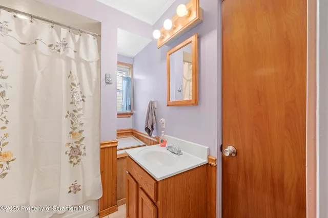 a bathroom with a sink and mirror