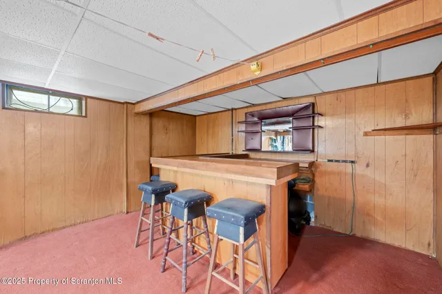 a dining room with furniture and a rug