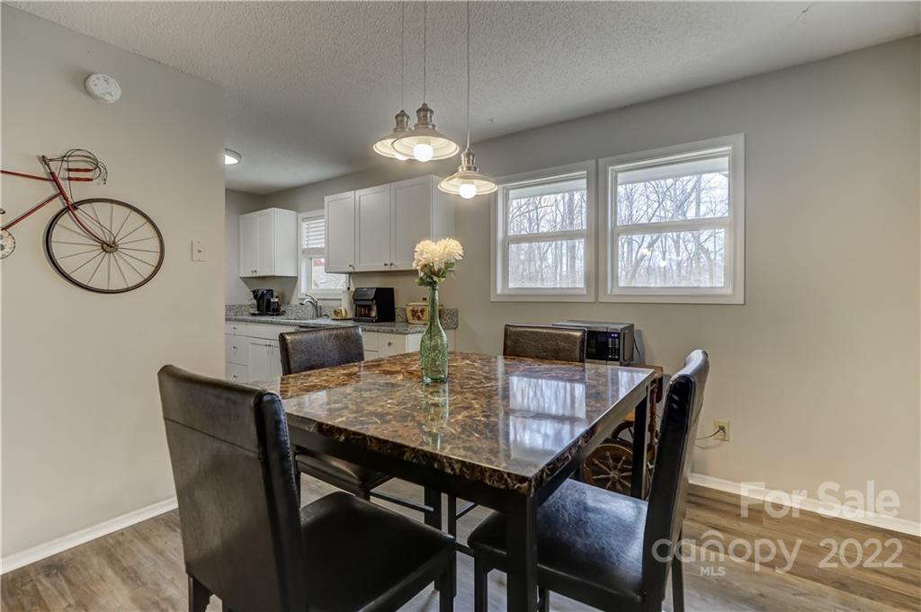 8216 Pine Oak Road Waxhaw, NC 28173 - Photo 13 of 39 a view of a dining room with furniture window and wooden floor