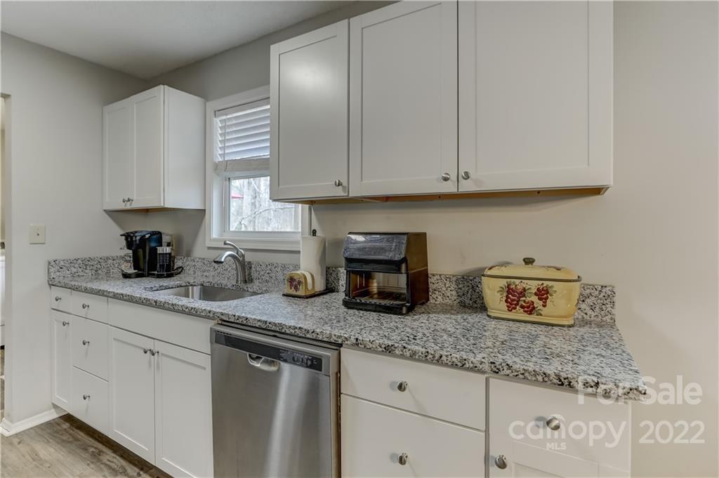 8216 Pine Oak Road Waxhaw, NC 28173 - Photo 14 of 39 a kitchen with granite countertop white cabinets and white appliances