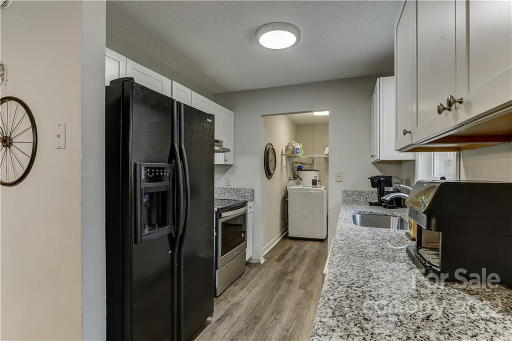 8216 Pine Oak Road Waxhaw, NC 28173 - Photo 15 of 39 a kitchen with a refrigerator and a stove top oven