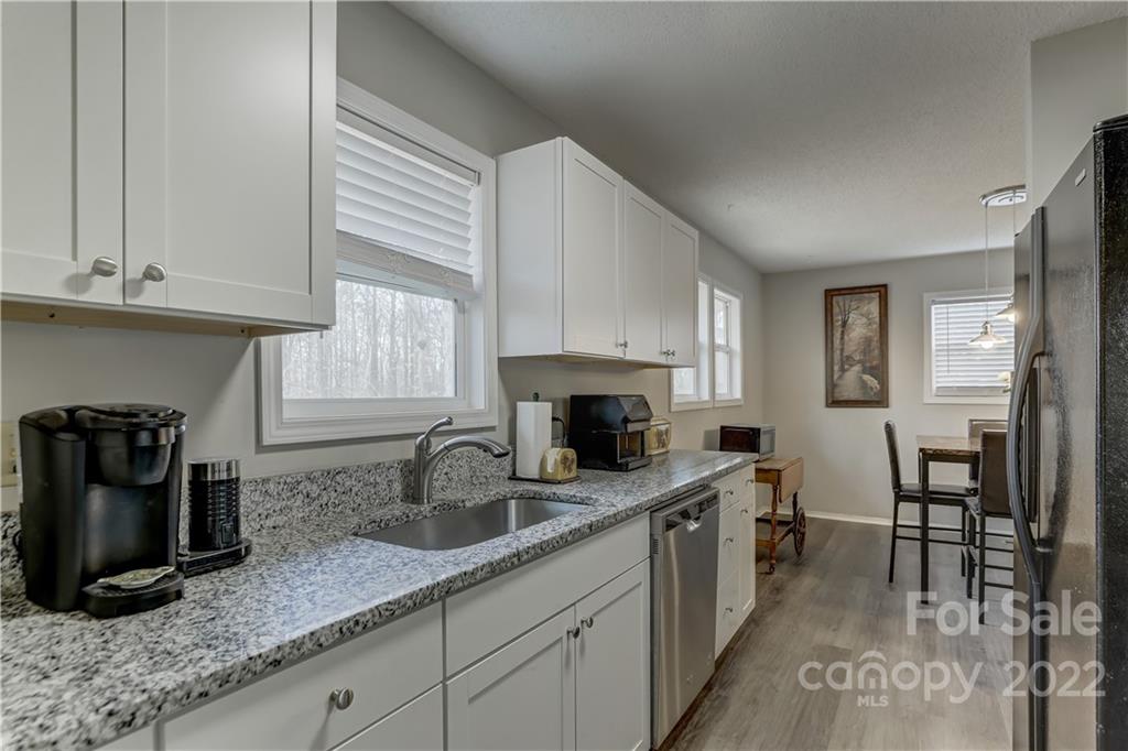 8216 Pine Oak Road Waxhaw, NC 28173 - Photo 16 of 39 a kitchen with granite countertop a sink a stove and cabinets