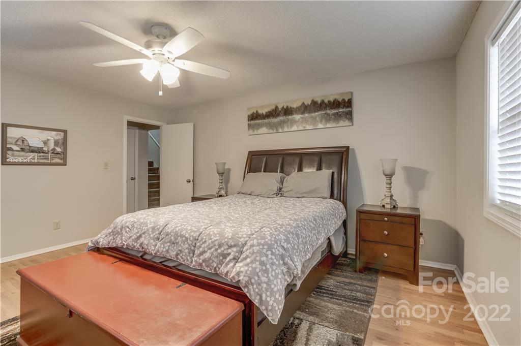 8216 Pine Oak Road Waxhaw, NC 28173 - Photo 20 of 39 a bedroom with a bed and a chandelier