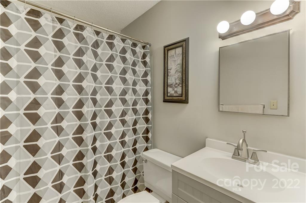 8216 Pine Oak Road Waxhaw, NC 28173 - Photo 21 of 39 a bathroom with a granite countertop sink and a mirror
