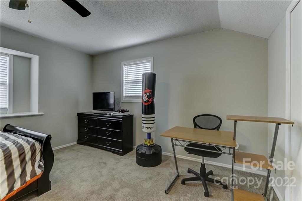 8216 Pine Oak Road Waxhaw, NC 28173 - Photo 23 of 39 a bedroom with a bed and a flat screen tv