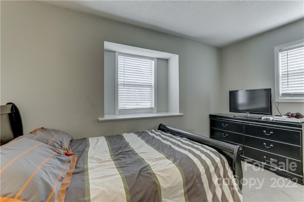 8216 Pine Oak Road Waxhaw, NC 28173 - Photo 25 of 39 a bedroom with a bed and a flat screen tv