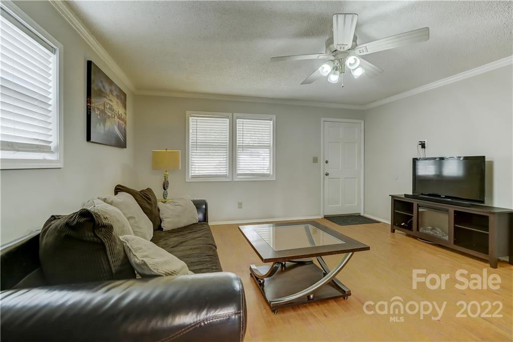 8216 Pine Oak Road Waxhaw, NC 28173 - Photo 9 of 39 a living room with furniture and a flat screen tv