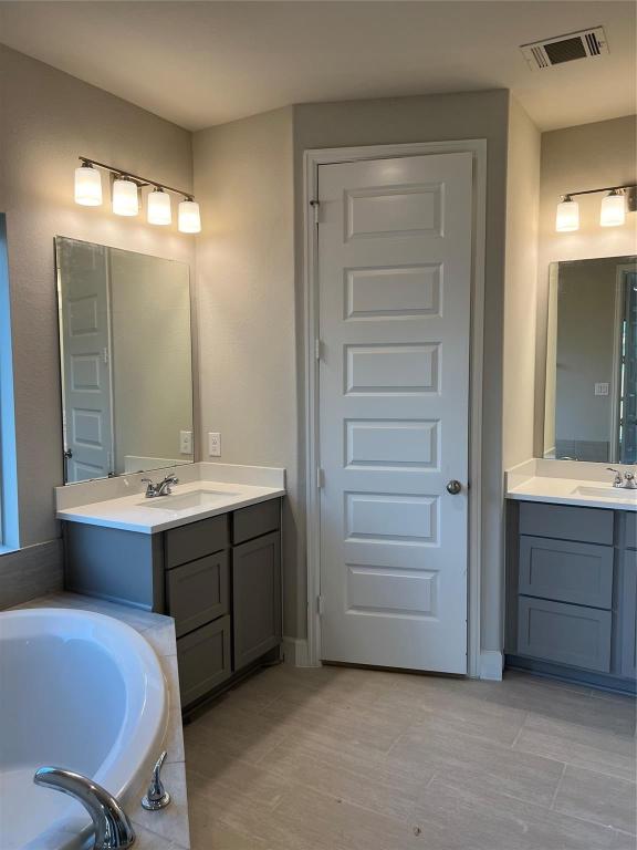 15707 Autumn Sun Conroe, TX 77302 - Photo 11 of 15 a bathroom with a tub sink and mirror