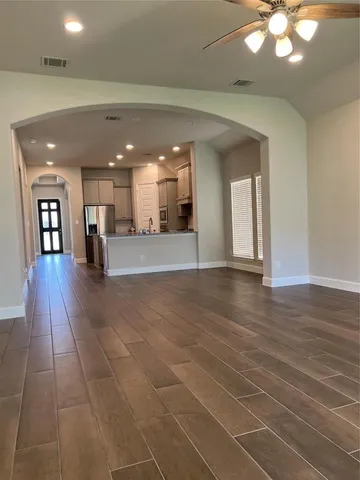 a kitchen with kitchen island granite countertop a sink a counter top space stainless steel appliances and cabinets