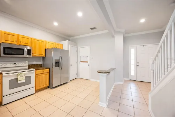 a kitchen with stainless steel appliances a refrigerator and a stove top oven