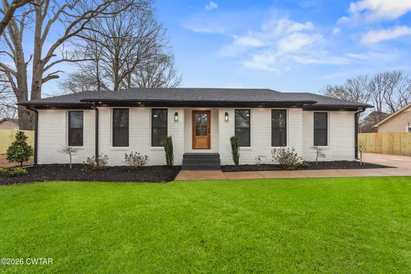 a front view of house with yard and green space