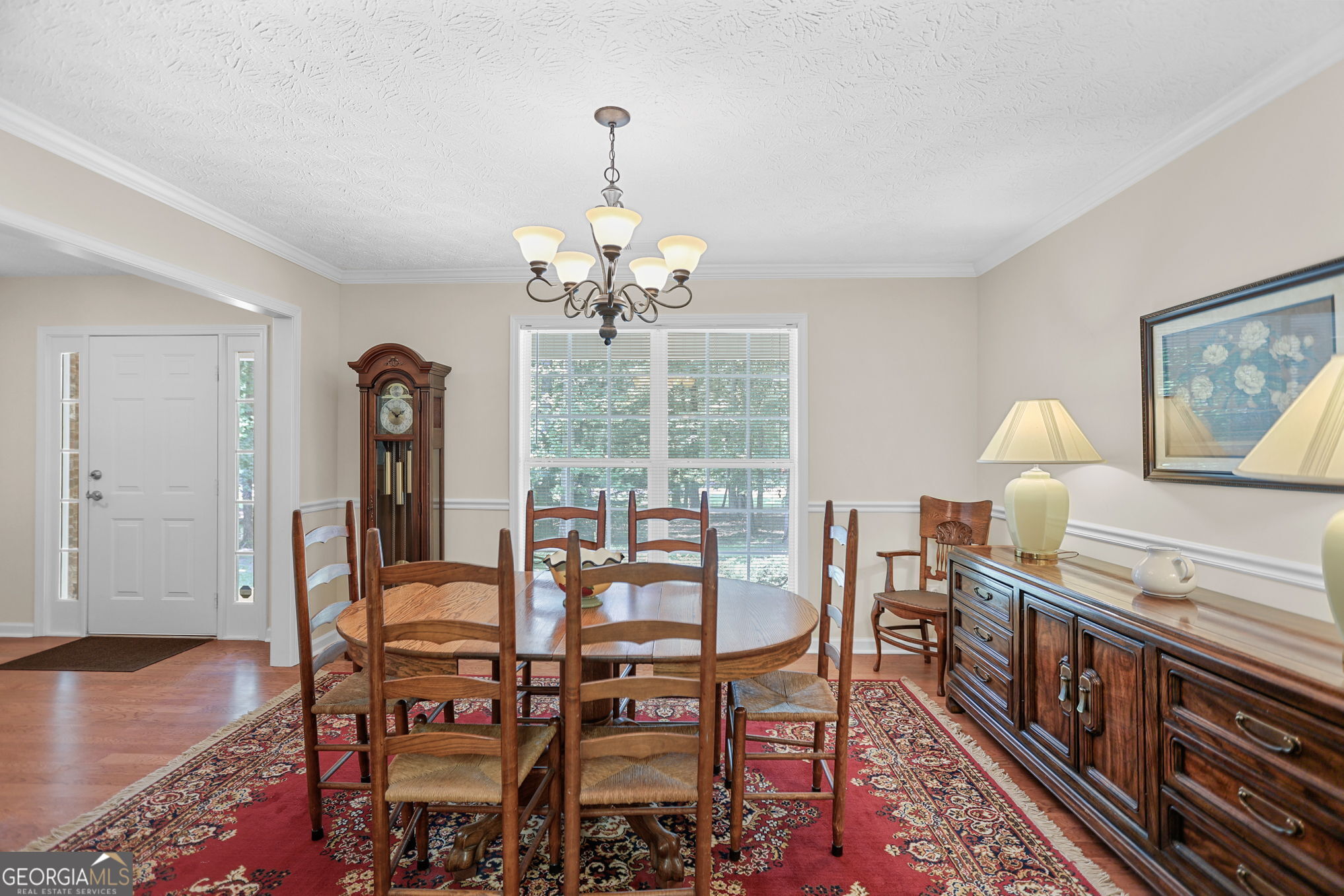 892 Brooks Woolsey Road Brooks, GA 30205 - Photo 9 of 45 a view of a dining room with furniture a chandelier and wooden floor