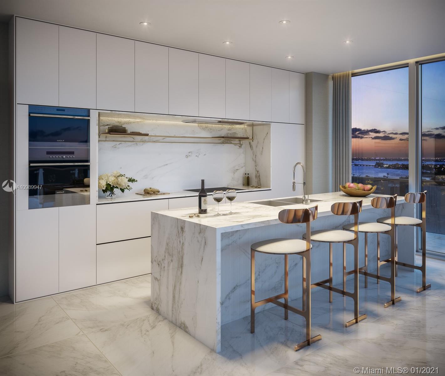 5775 Collins Avenue, Unit PH Miami Beach, FL 33140 - Photo 10 of 23 a kitchen with a sink and chairs