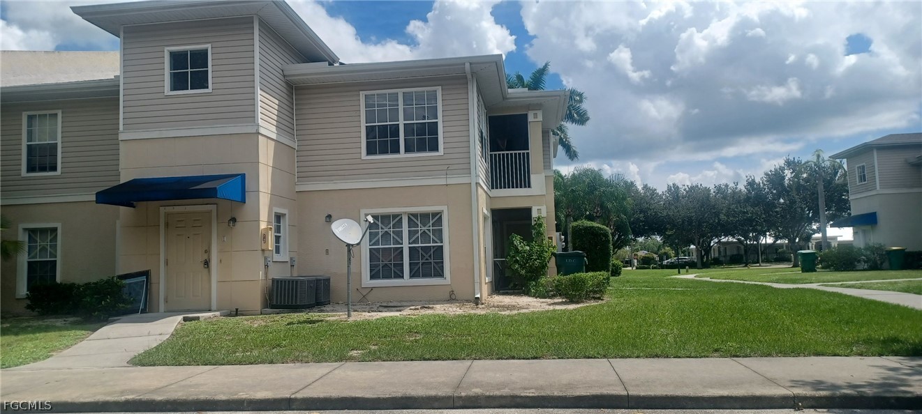 1328 Reflections Way, Unit 1 Immokalee, FL 34142 - Photo 1 of 8 a view of a house with a yard and large tree