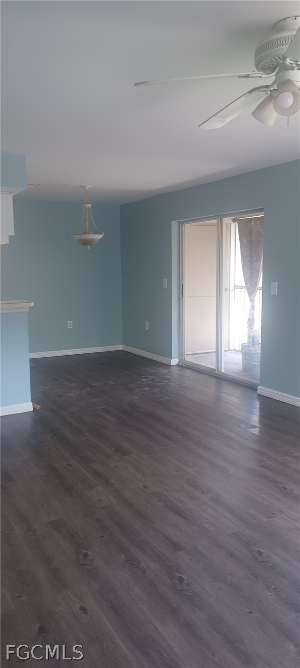 1328 Reflections Way, Unit 1 Immokalee, FL 34142 - Photo 6 of 8 an empty room with wooden floor and windows