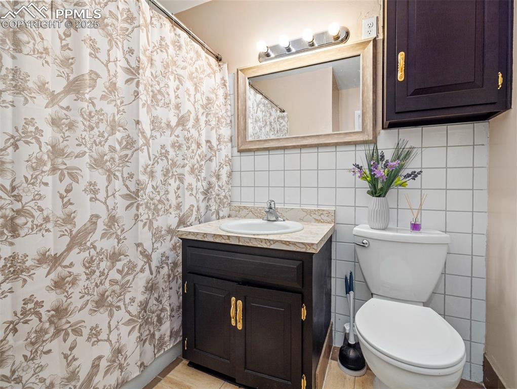 2123 Ridgewood Lane Pueblo, CO 81005 - Photo 11 of 19 a bathroom with a toilet a sink and a mirror