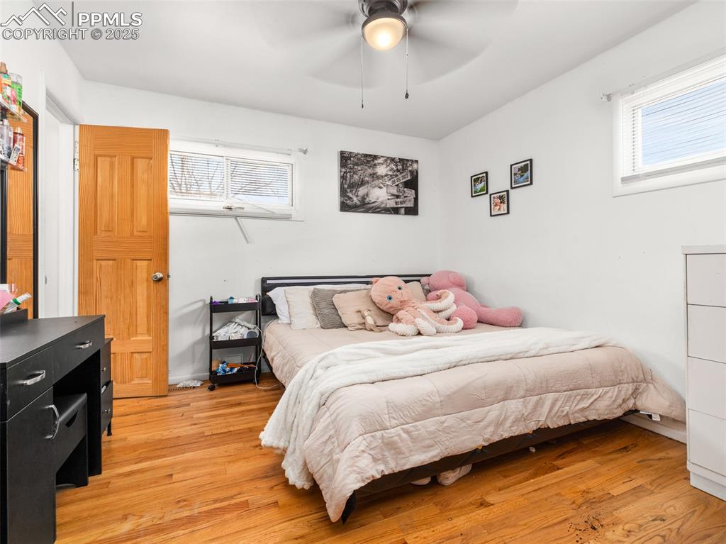 2123 Ridgewood Lane Pueblo, CO 81005 - Photo 12 of 19 a bedroom with a bed and wooden floor