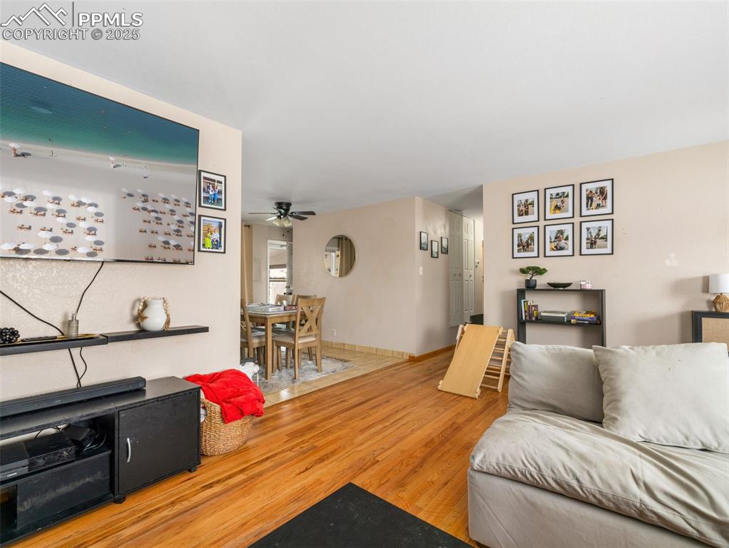 2123 Ridgewood Lane Pueblo, CO 81005 - Photo 6 of 19 a bedroom with a bed and wooden floor