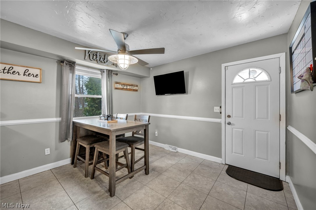 13800 Milo Road Garfield Heights, OH 44125 - Photo 11 of 39 Dining room with ceiling fan and light tile patterned floors