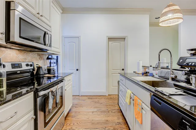 a kitchen with stainless steel appliances granite countertop a stove and a sink