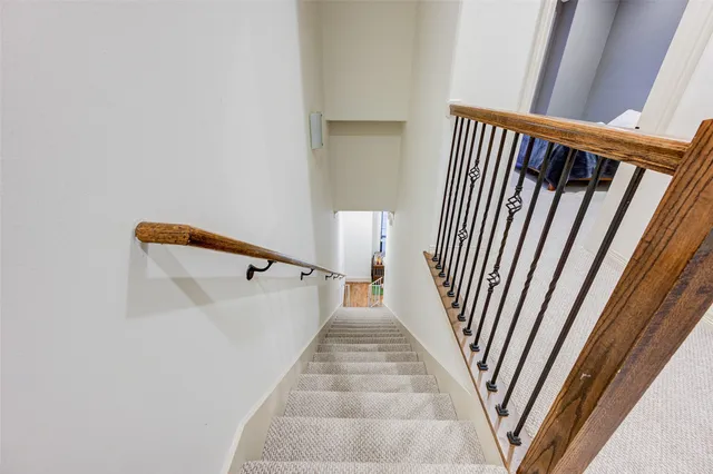 a view of staircase with white walls and a window