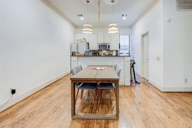 a view of a kitchen with a sink and wooden floor