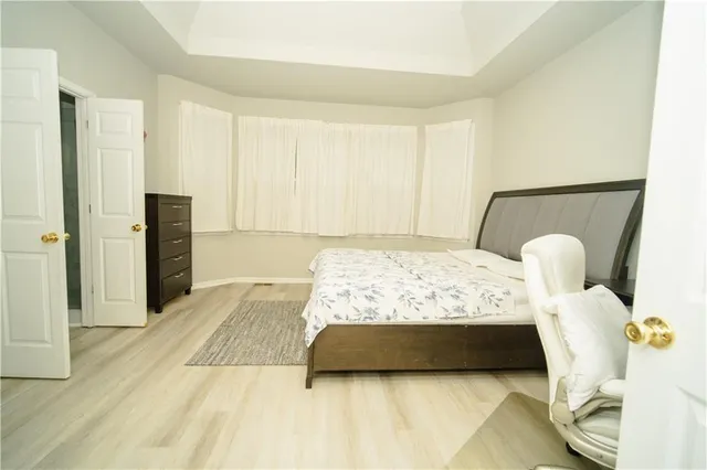 a bedroom with a bed and with furniture