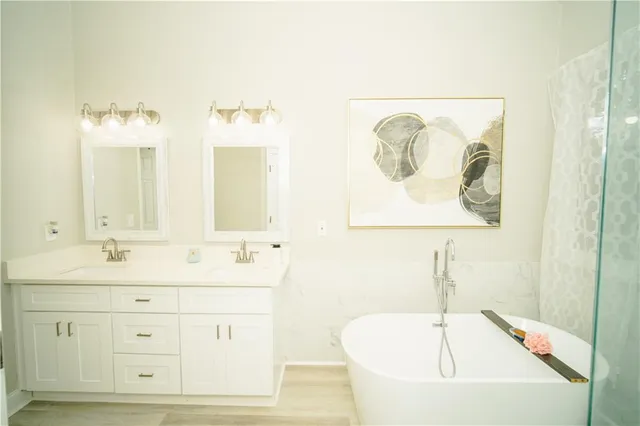 a bathroom with a double vanity sink mirror and toilet