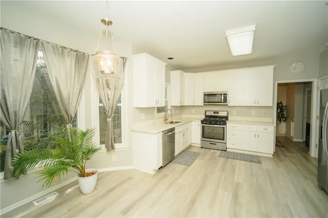 a kitchen with a sink stove and cabinets