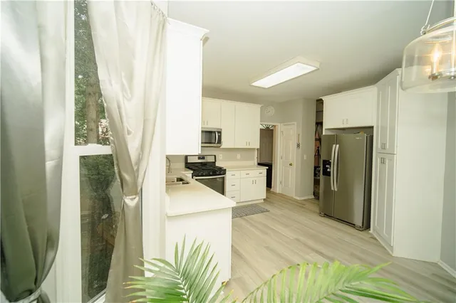 a kitchen with a sink stove and microwave
