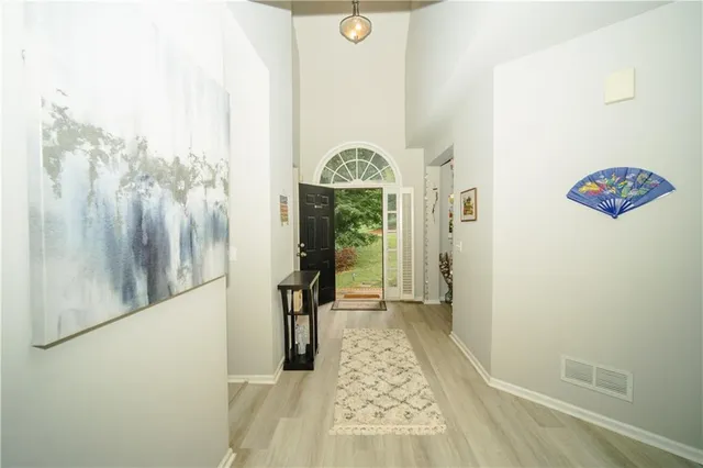a view of a hallway with wooden floor and staircase