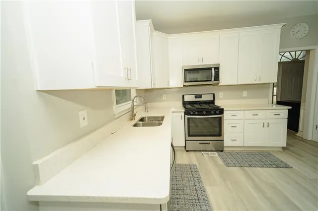 a bathroom with a sink a mirror and a window