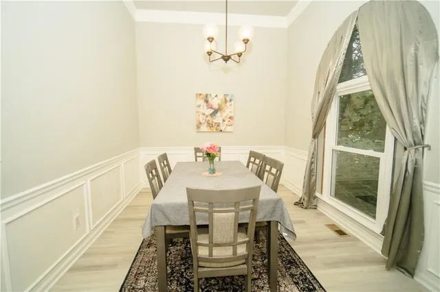 a view of a dining room with furniture and a chandelier