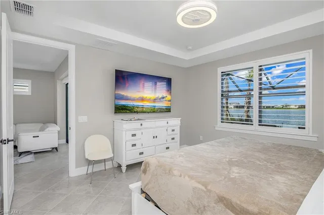 a bedroom with furniture and a flat screen tv