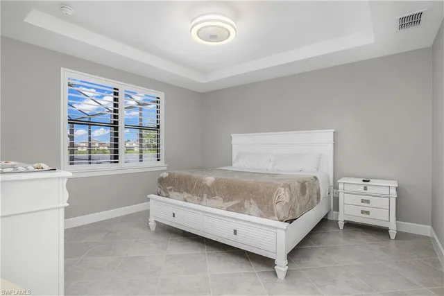a spacious bedroom with a bed and a window