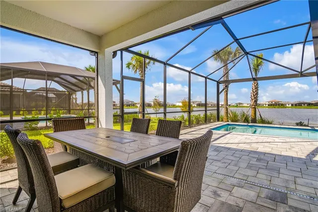 a view of a patio with table and chairs under an umbrella