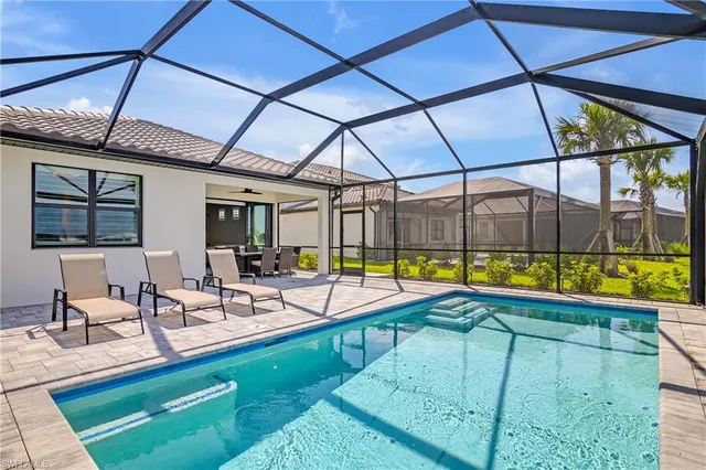 a view of swimming pool with chairs