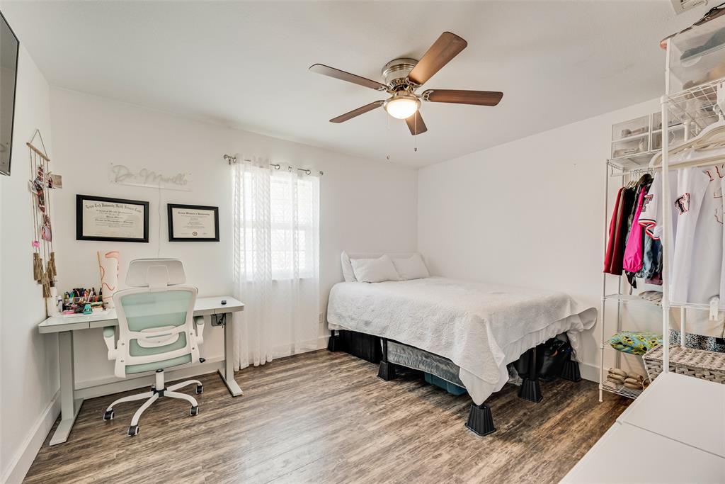 1624 Cemetery Road Royse City, TX 75189 - Photo 12 of 40 a bedroom with a bed a desk and chair with wooden floor